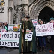 Campaigners with Stonehenge Alliance outside the High Court in central London on Tuesday, December 12, 2023.
