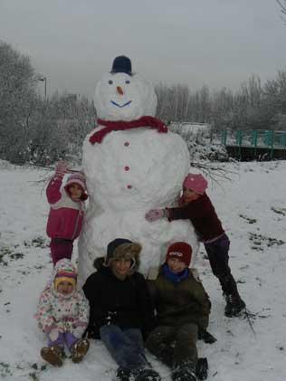 A job well done. Children pictured with snowman in Riverside Road, Watford, by Aldona Mallaci-Mercurio