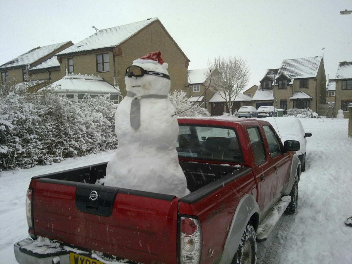 Back seat driver: snowman hitches a ride 