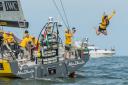 Comedian Dom Joly jumps from onboard Abu Dhabi Ocean Racing at the start of Leg 6 in Itajai