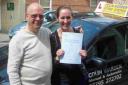 Corey Ross celebrates her driving test pass with instructor Colin Warden.