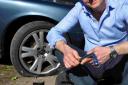 CAR MISERY: TV reporter Richard Gaisford with his damaged tyre.