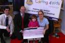 Chris Bush of Moore Stephens presents a cheque for £10,000 to the Stars Appeal team