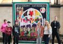 Beth Hughes, Cathedral curator (left) with Ben Mousley, Lecturer in Art & Design (right) and students Stevie, Maddy, Niamh and Michaela in front of Ed Hall banner