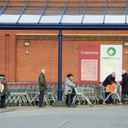 People observe social distancing while queuing at a Sainsbury's supermarket the day after Prime Minister Boris Johnson put the UK in lockdown to help curb the spread of the coronavirus. Picture: Danny Lawson/PA Wire