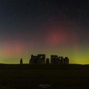 A stunning photograph of aurora borealis over Stonehenge, taken by Stonehenge Dronescapes on Facebook