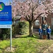 Mrs Kate Malcolm and children outside Winterslow Primary School