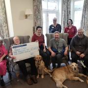 Braemar Lodge residents Catherine Brighty and, holding cheque, Douglas Parish; Katie Ransby and Queenie; Justin Wright with Ned; and Richard Burt with Dilly.