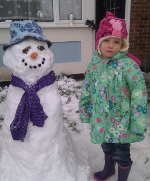 Rebecca Korbey with her first proper snowman. Picture by Louise Korbey.