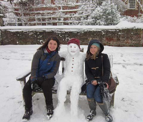 Pascale Costello and Rebecca Allenby pose for a picture with their snowman Sir Schnizzle Snowalot in the Cathedral Close.
