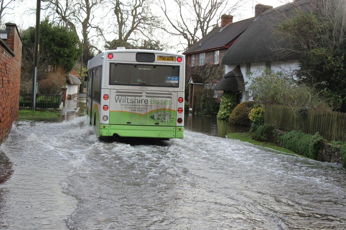 A bus struggles through the floods in Coombe Bissett. By Laura Dale