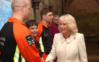 Queen Camilla is greeted by air ambulance charity reps