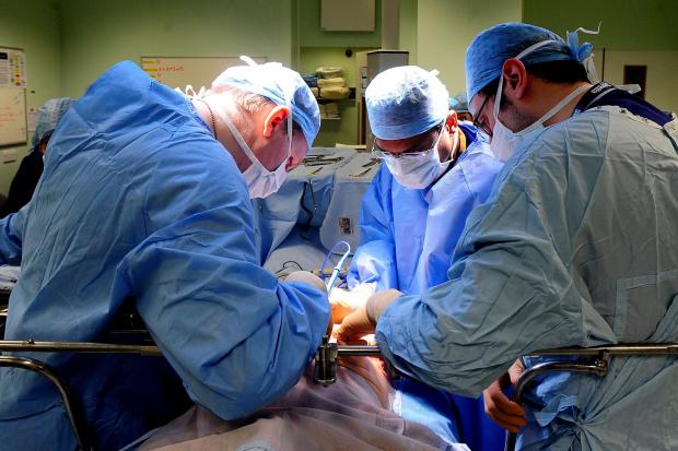 File photo dated 7/4/11 of an operation taking place. An extra 290,000 operations could be carried out on the NHS every year if the way theatre lists are managed was improved, a national review has found.
