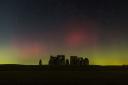A stunning photograph of aurora borealis over Stonehenge, taken by Stonehenge Dronescapes on Facebook