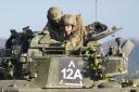 The Prince of Wales, Colonel-in-Chief, 1st Battalion Mercian Regiment (right) rides in a Warrior Armoured Fighting Vehicle as he takes part in an attack exercise during a visit to the regiment, in the south west of the UK, for the first time following