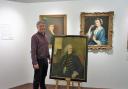 Adrian Green, the director of Salisbury Museum, with the portrait of Salisbury Journal co-founder Benjamin Collins