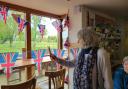 Peter Arnold's sister Jean Bunch cuts the bunting of the seating area newly dedicated to Peter.