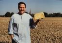 Robert Lewis holding a loaf of bread made using wheat grown in the field off Downton Road.