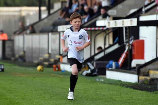 This 7-year-old raised nearly £1000 for his ill brother as a Salisbury FC mascot. Photo by Roger Elliott