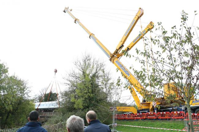 A 'locked in' train carriage being removed from crash site by crane yesterday. Picture by Spencer Mulholland