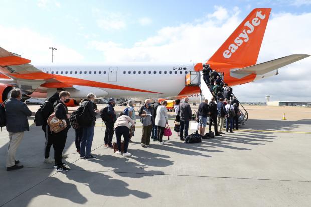 Salisbury Journal: People queue to board an EasyJet plane. (PA)