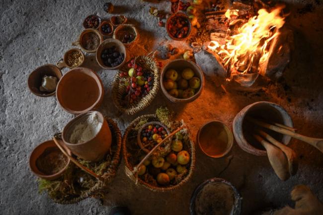 Volunteers bake Neolithic inspired mince pies around the hearth  at Stonehenge. Photo credit: PA/ Andre Pattenden from English Heritage