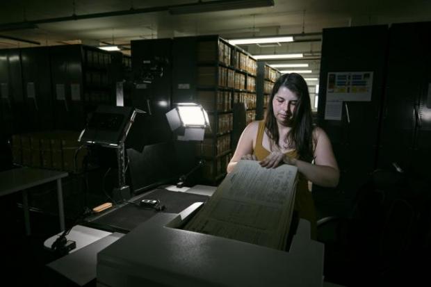 Salisbury Journal: Photo via PA shows Findmypast technician Laura Gowing scans individual pages of the 30,000 volumes of the 1921 Census at the Office for National Statistics (ONS) near Southampton.