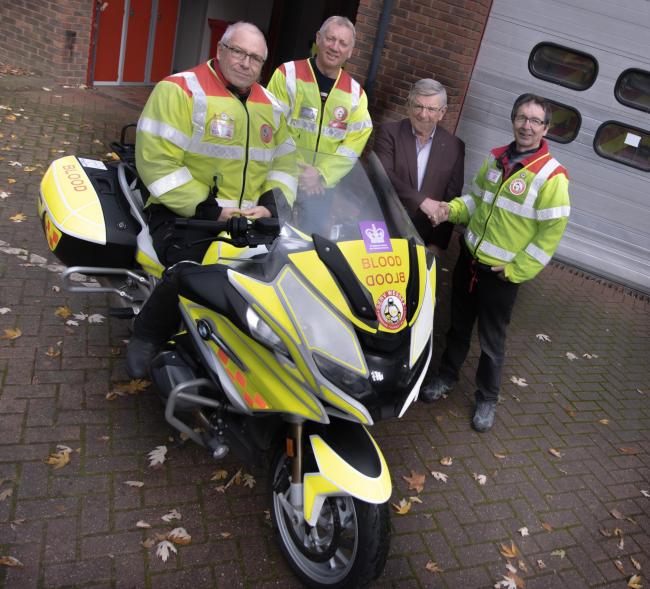 Volunteer Robert Smith on the bike with Steve and Dave Luckett, and Tim Bennett, the charity's trustee and treasurer