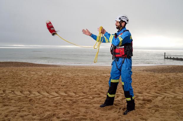 Salisbury Journal: HM Coastguard Coastal Operations Area Commander Tom Wright casts a throwline on Southbourne beach in Dorset (PA)