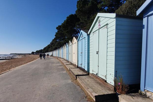 Beach huts at Avon Beach in Christchurch, which have been extended out onto the promenade in recent years