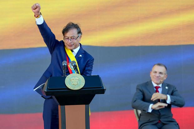 President Gustavo Petro raises his fist at the end of his inauguration speech in Bogota, Colombia, Sunday, August 7, 2022