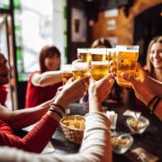 People drinking beer in a pub, but drinking alcohol is declining among today’s young adults