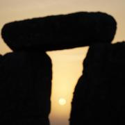 The sun begins to rise behind the stones during the summer Solstice at Stonehenge, June 21, 2022. Picture from PA Wire/PA Images/Andrew Matthews