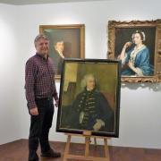 Adrian Green, the director of Salisbury Museum, with the portrait of Salisbury Journal co-founder Benjamin Collins