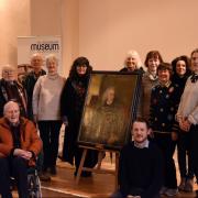 Some past and present Salisbury Journal staff with the painting of its co founder  Benjamin Collins at Salisbury Museum.