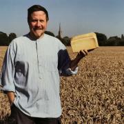 Robert Lewis holding a loaf of bread made using wheat grown in the field off Downton Road.