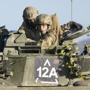 The Prince of Wales, Colonel-in-Chief, 1st Battalion Mercian Regiment (right) rides in a Warrior Armoured Fighting Vehicle as he takes part in an attack exercise during a visit to the regiment, in the south west of the UK, for the first time following