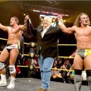 ASW South owner Joel Pettyfer alongside his tag team partner Adrian Neville at WWE NXT in 2013.