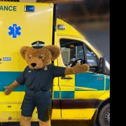 Ewan McNeil (centre) with his grandad, Roland Revell (left), and the new South Western Ambulance Service mascot, Roly Bear.