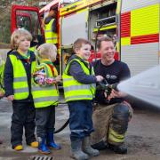 Young scouts visit fire station and shoot fire hose