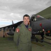 Wing Commander Tom Lyons, commanding officer of the Fast Jet Test Squadron at Boscombe Down, with a Harrier GR9.