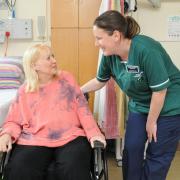 Senior nursing assistant Lindsey Boase with a patient on the spinal centre