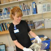 Lesley Meaker goes through some of the material to be archived in a special project
