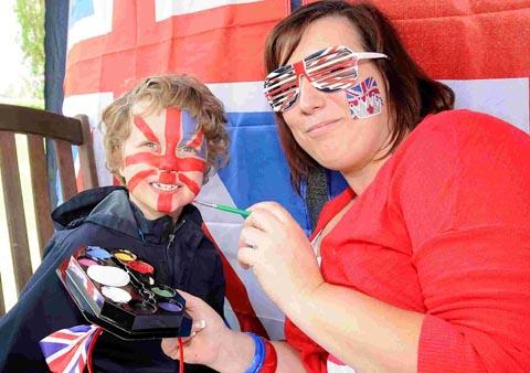 Kerry Edmunds helps little Archie get in the jubilee spirit with some patriotic face painting. DC1665P2
