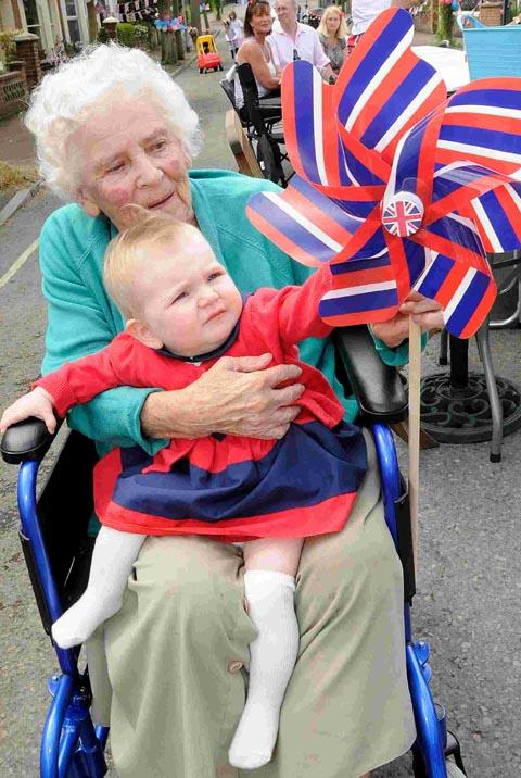 94-year-old Gladys Ackland with eight-month-old Neve Baker at the St Andrews Road celebrations. DC1666P5