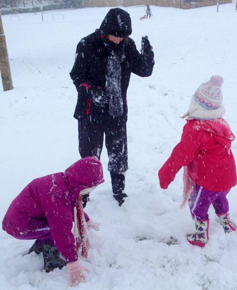 The Glover family having a snowball fight.