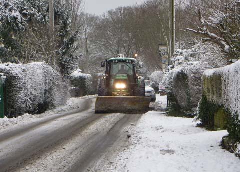 A tractor helps out with some unofficial road clearing in Winsor, Hampshire. Taken by Bruno Clements.