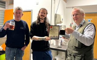 Aaron Lewis (centre) of Dark Revolution receives the Beer of the Festival award from CAMRA’s local festivals co-ordinator Andrew Hesketh (right) and CAMRA branch chairman Chris White (left).